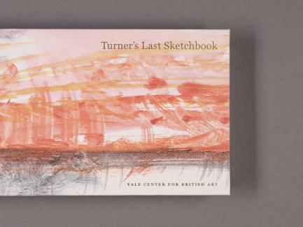 photo of a small book with a pink landscape on its cover