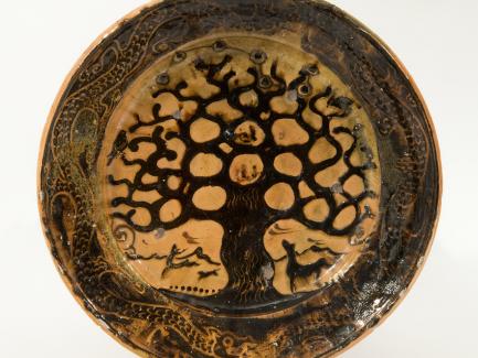 Bernard Leach, Charger, Tree of Life, 1923–25, earthenware, brown slip, and a galena glaze, The John Driscoll Collection, New York, photograph by Joshua Nefsky