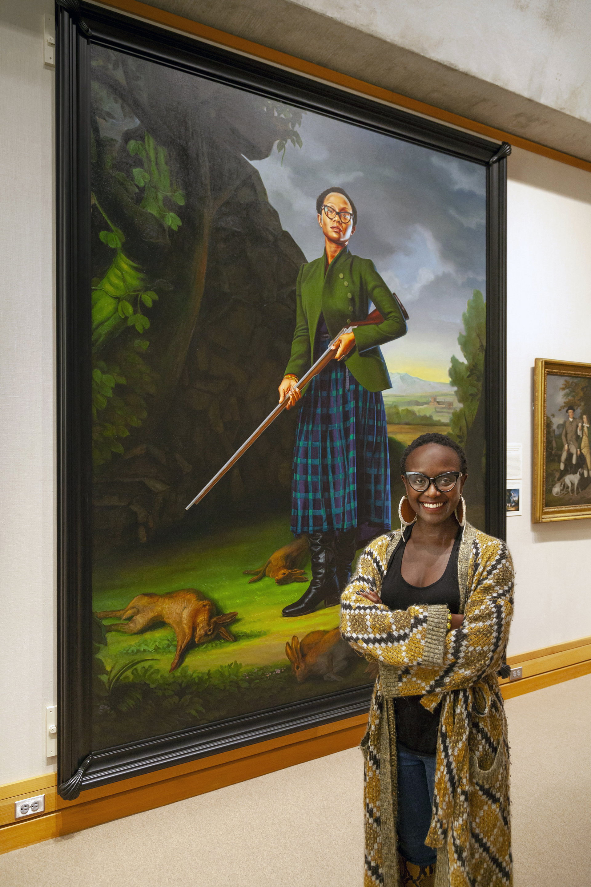 Lynette Yiadom-Boakye stands in front of her portrait by Kehinde Wiley, photo by Harold Shapiro