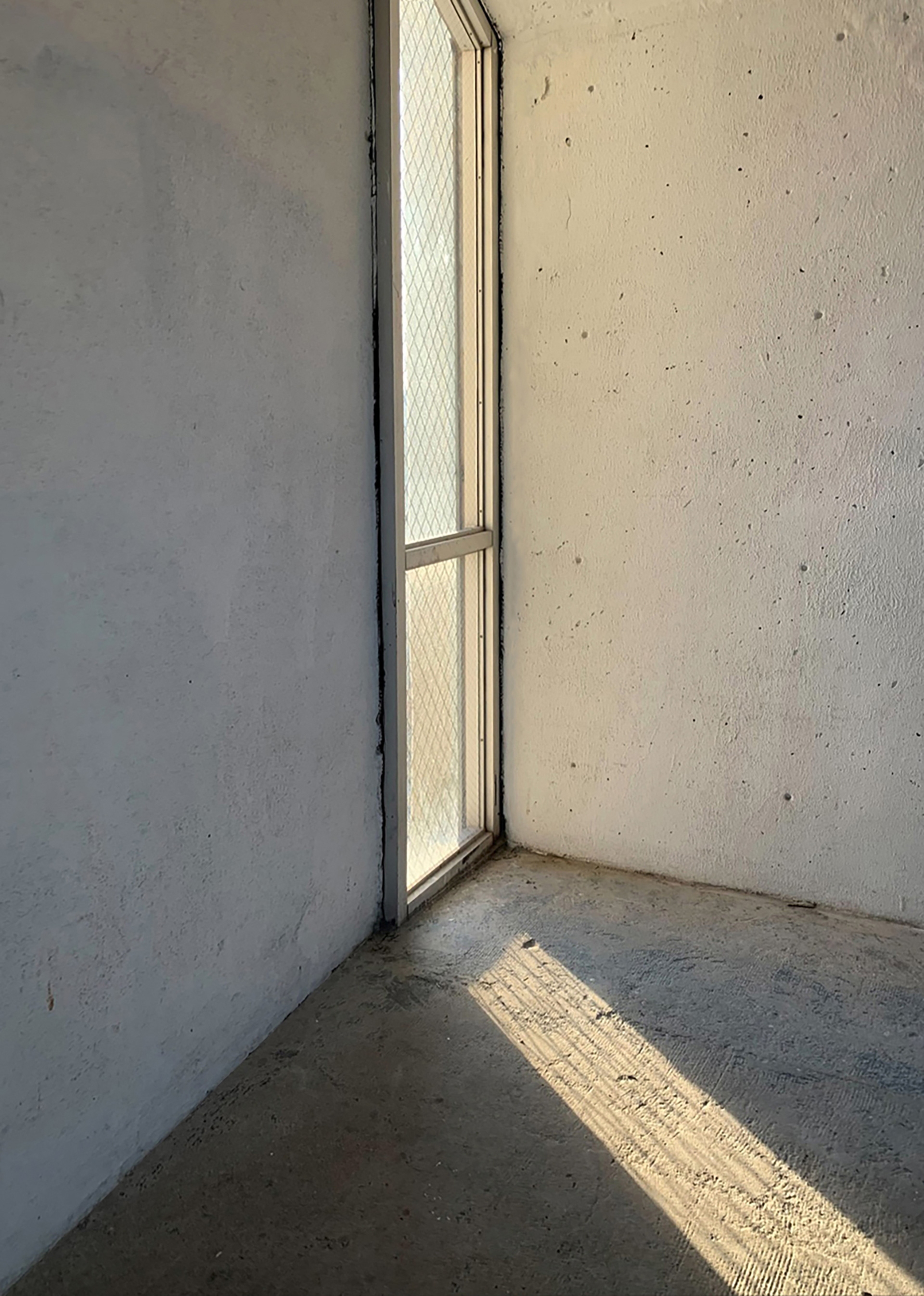 Photo of a window with a strong cast shadow on the floor