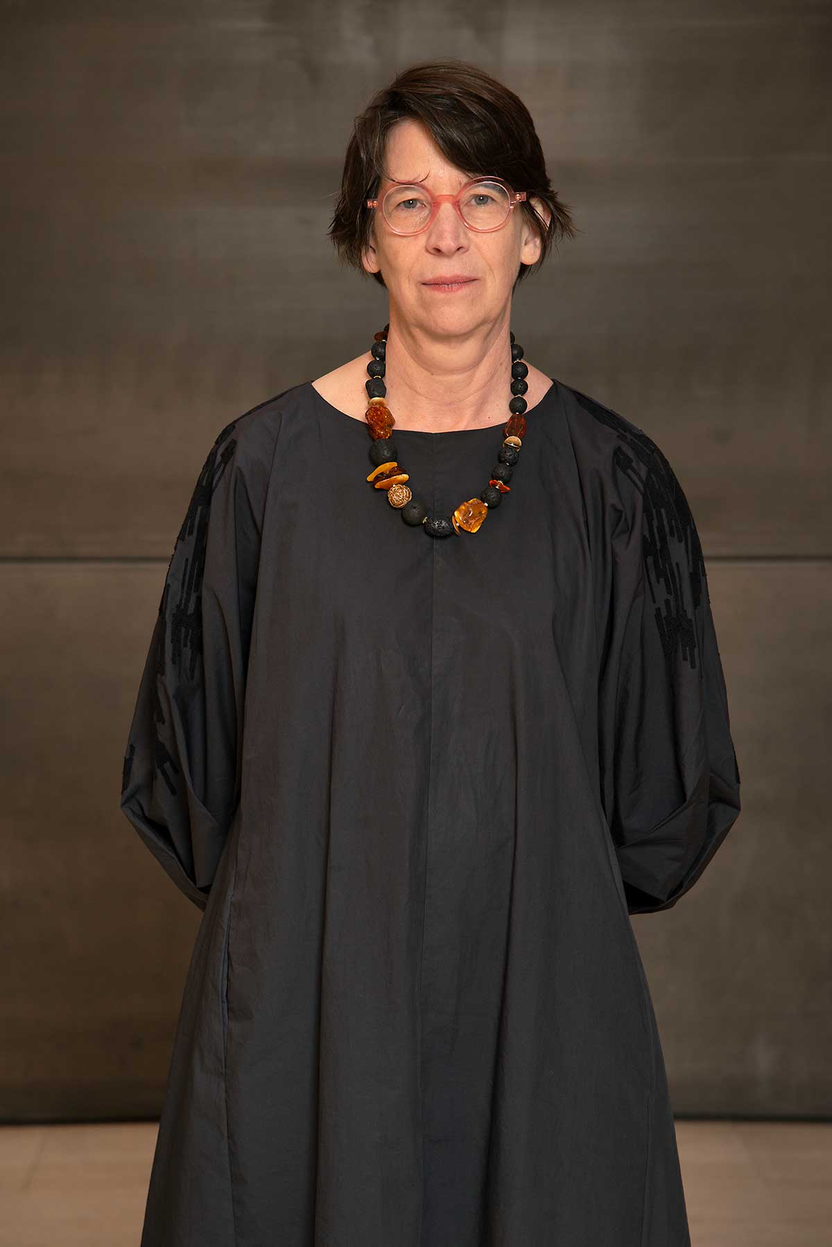 headshot of a woman wearing a gray dress