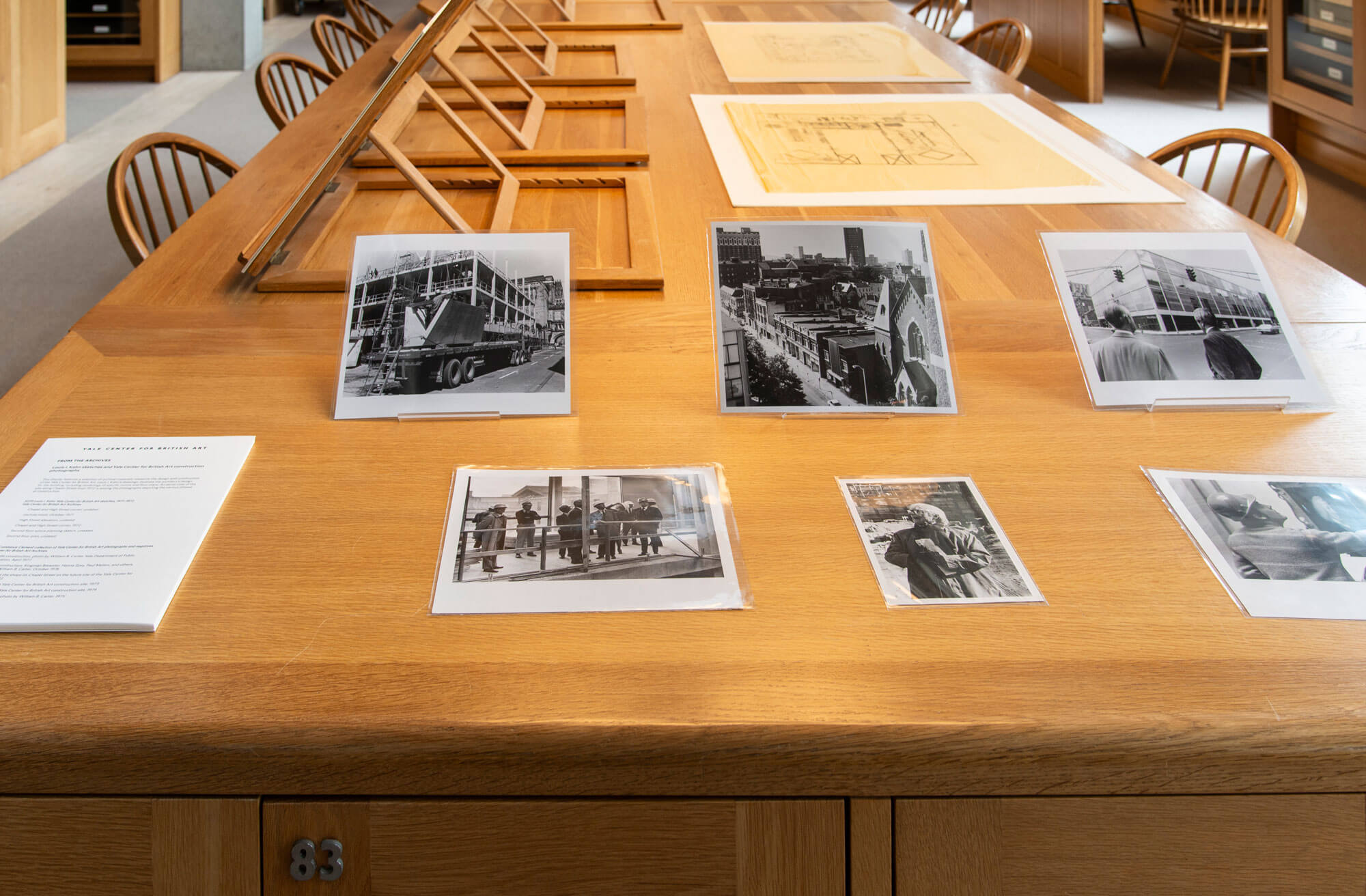 black and white photographs on a wooden desk