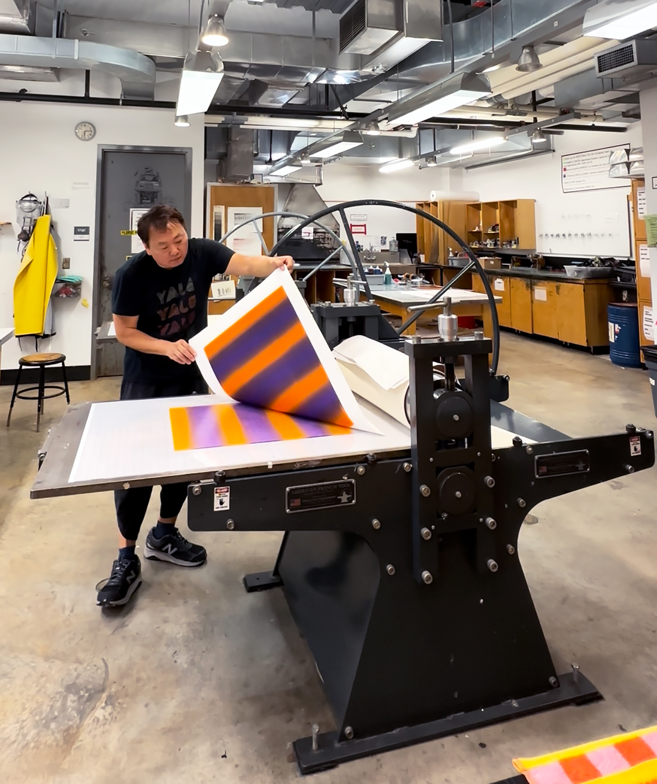 man in front of a printing press