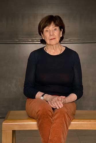 seated woman wearing a dark top