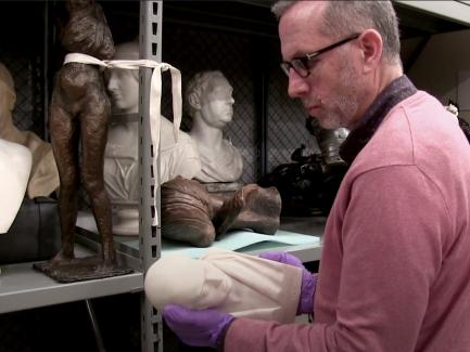 Richard Johnson, Chief of Installation at the Center, holding a sculpture