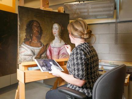 woman treating a painting