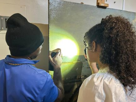 photo of people looking at a painting